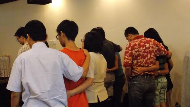 Families gathered together in prayer after the service