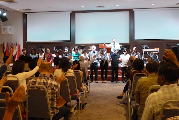 Congregation praying for the missionary team of the church