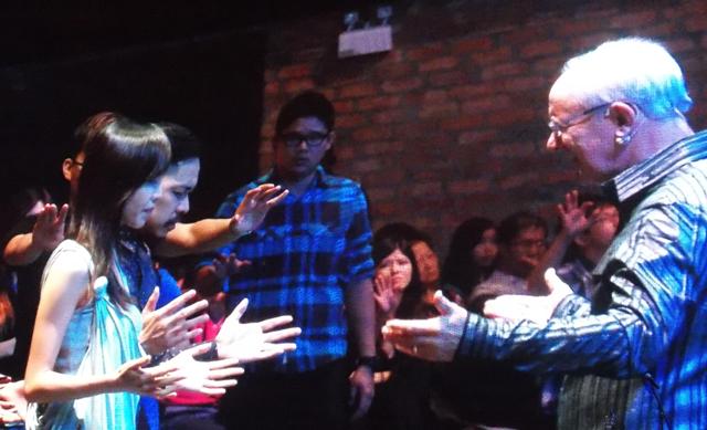 Rev Mike Connell praying for Senior Pastor Kevin Loo and his wife as they marked their 8th anniversary together