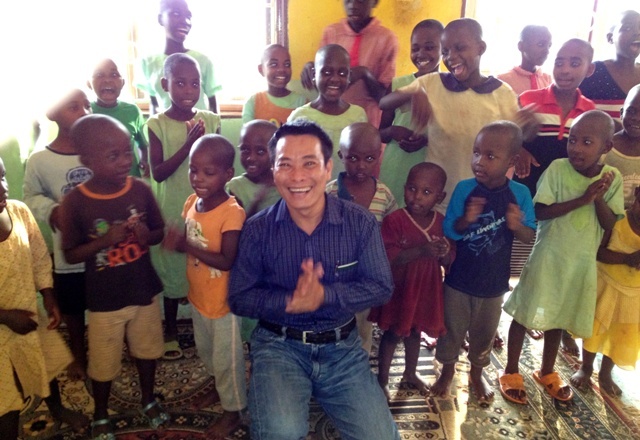 Tony with Ugandan orphans in Africa, 2013