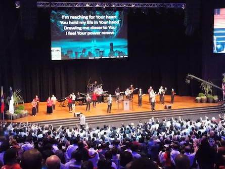 The attendees coming to the front of the stage for prayer