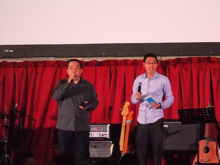 Pr Shawn Kong (right) making church announcements on-stage