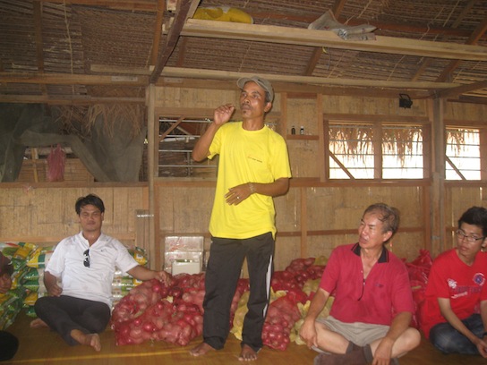 One of the Orang Asli villager speaking on behalf of them, with sacks of food behind him