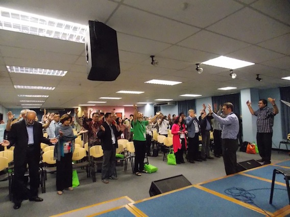 All the pastors raising their hands in prayer