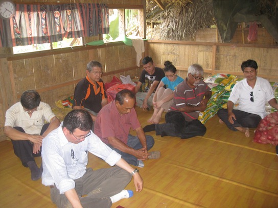 The missionary team bowing their heads in prayer