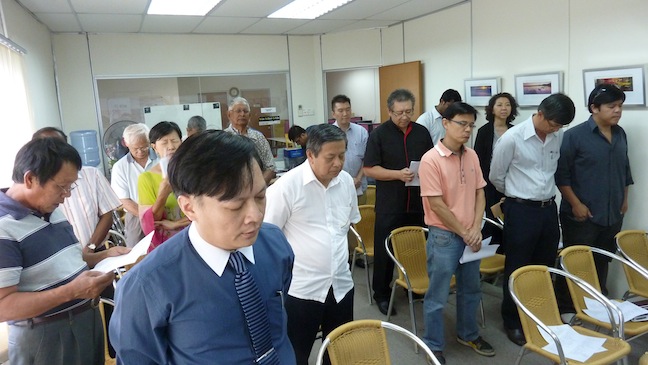 FGB members bowing heads in prayer