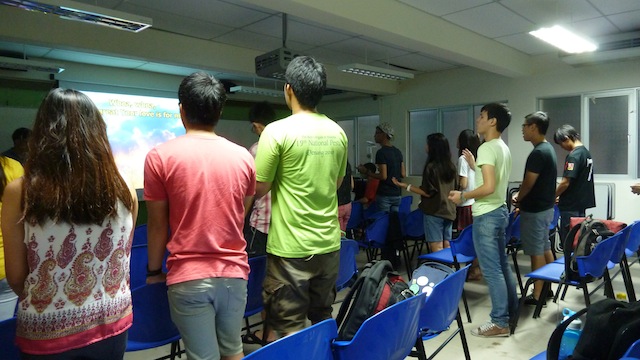 Students standing up to worship God