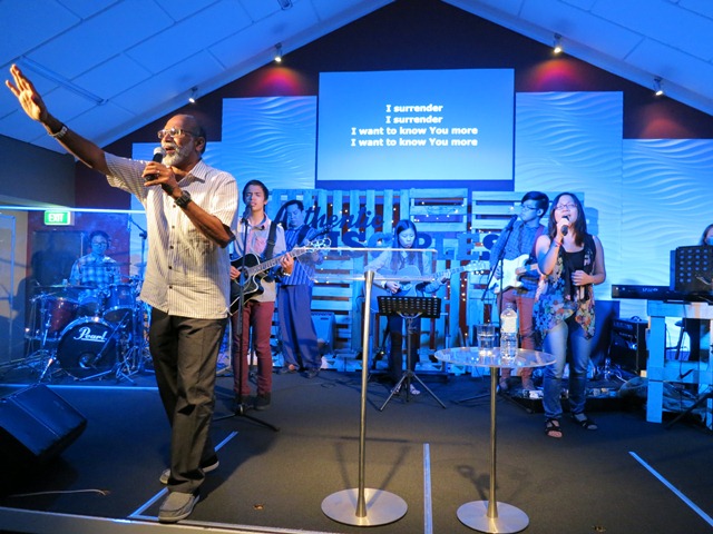 Pastor Benedict Rajan with the worship team during the altar call