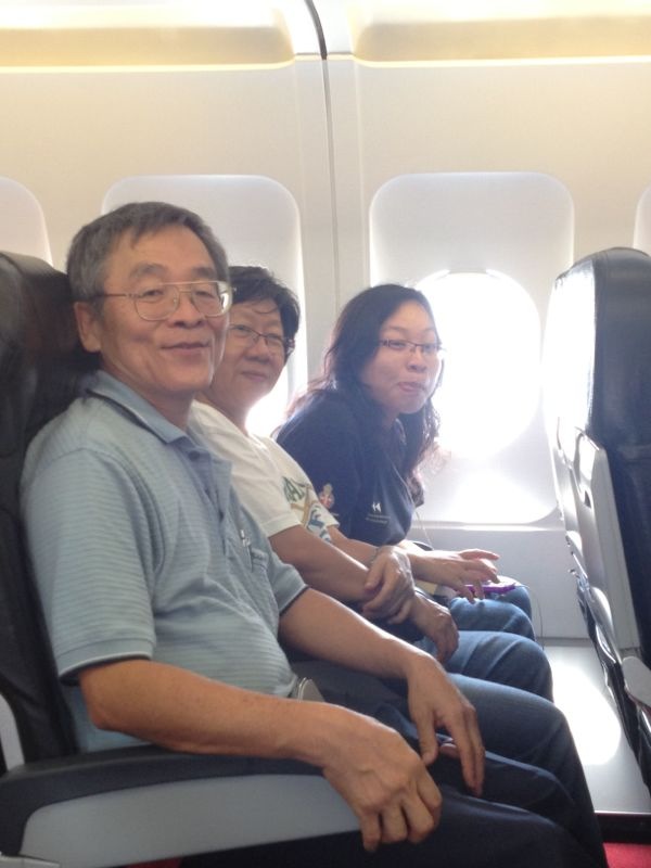 Serena with her mum and dad in an air flight