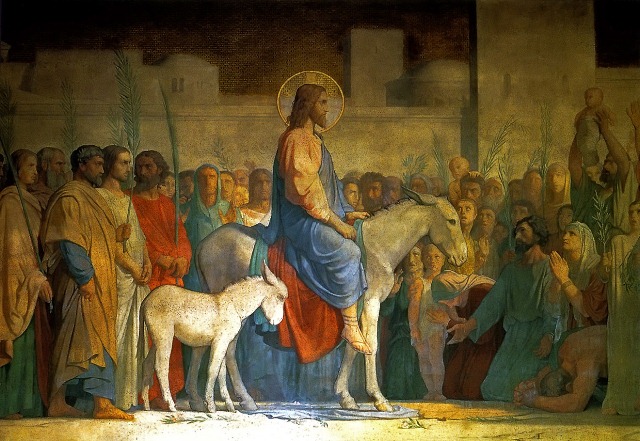 Christ entering Jerusalem on a donkey, with large crowds spreading cloaks and branches (Matthew 21)