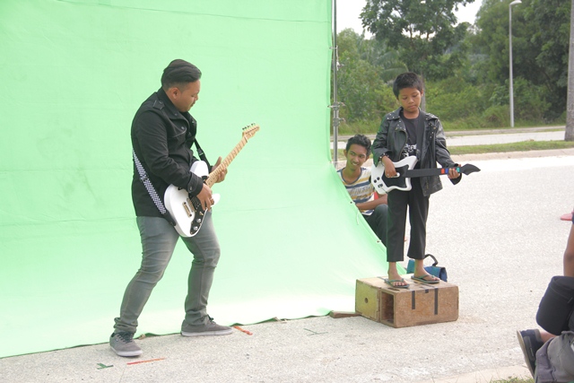 he musical band of the film soundtrack in front of a green screen on Putrajaya highway