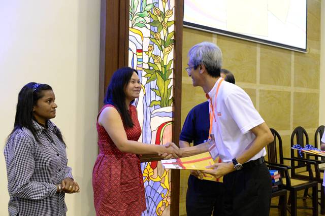 Wong Young Soon presenting Kursus Kewangan Komuniti to Amelia Leong from World Vision Malaysia