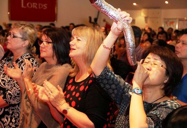 An attendee blowing a shofar