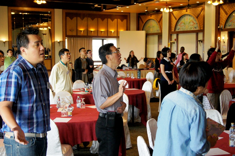 Participants worshiping God before the session began