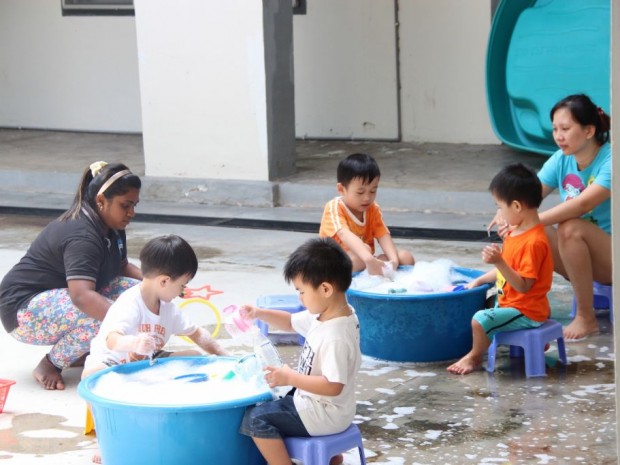 Children enjoying some time outside with water activities 