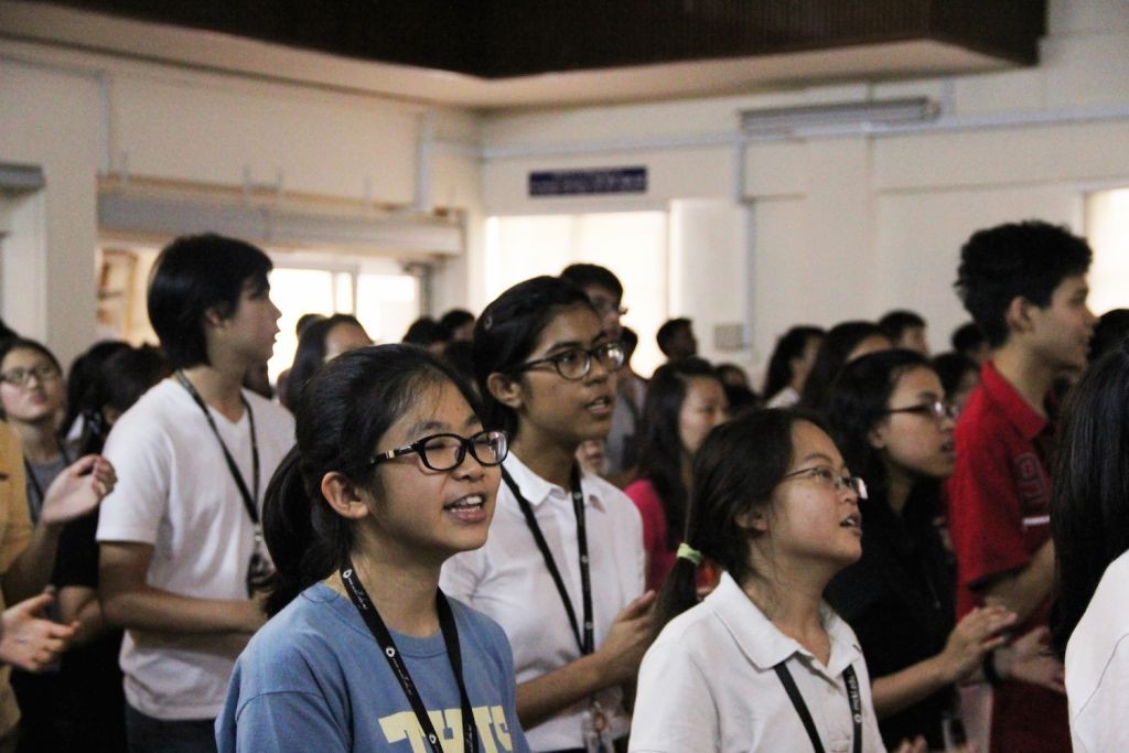 Students lifting their voices together in worship 