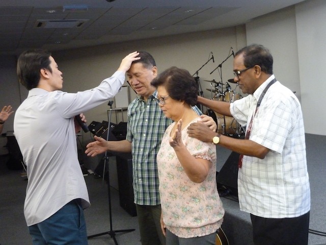 Pr Steve laying hands to pray for the founding team of NLCC with Pr Dennis Balan