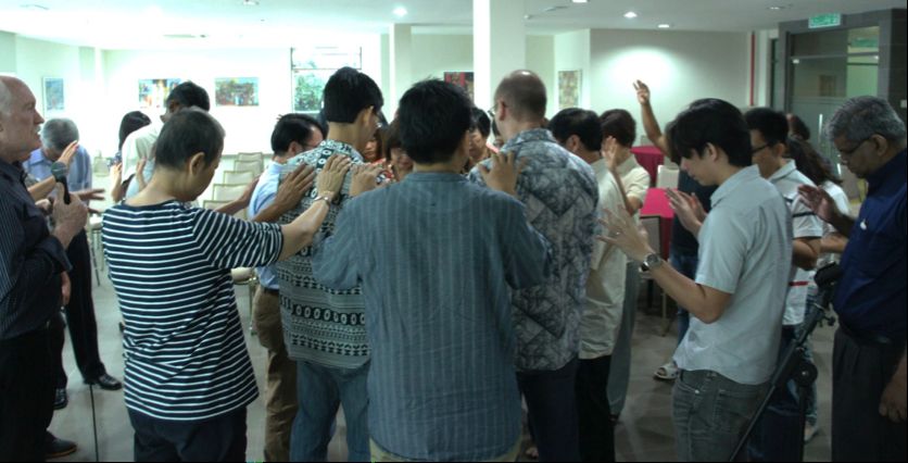 Gathering around the Simply Mobilizing Malaysia team as Rev. Max prayed over them and their ministry. 