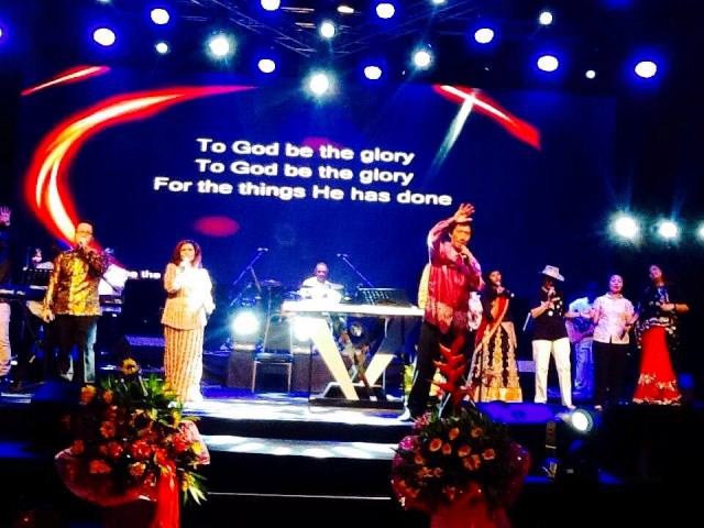 Rev Dr Paul Ang (most front) worshipping God onstage 