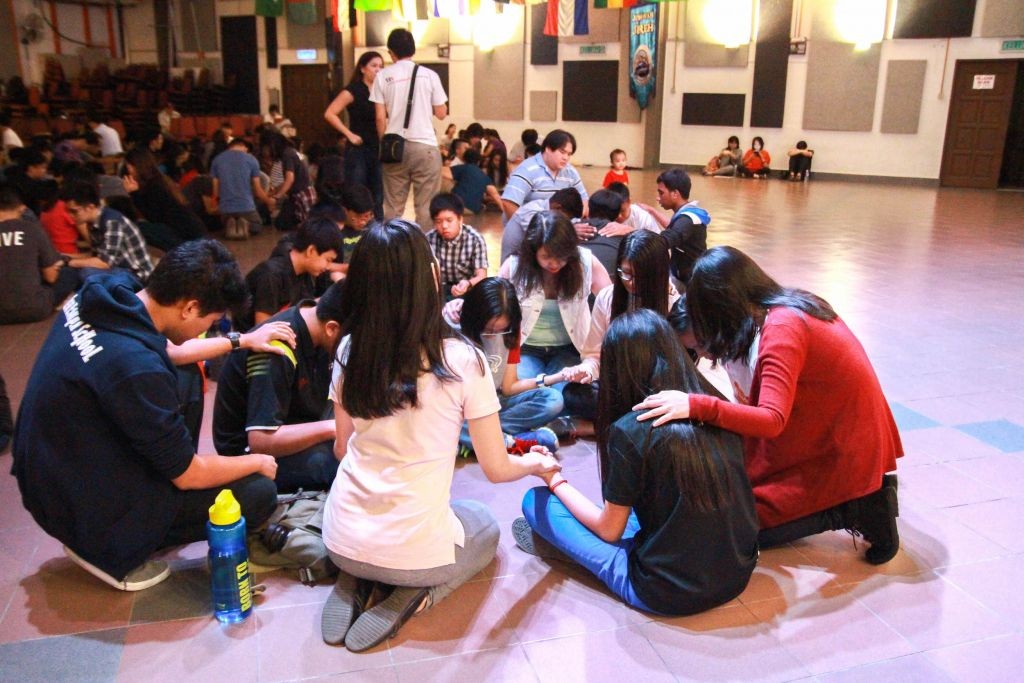 Praying over the youth Photo Credit: Naaman Foong