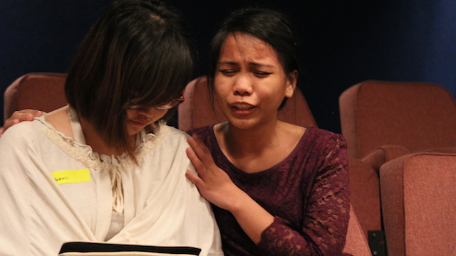 A sister-in-Christ praying for healing for an attendee in the healing crusade