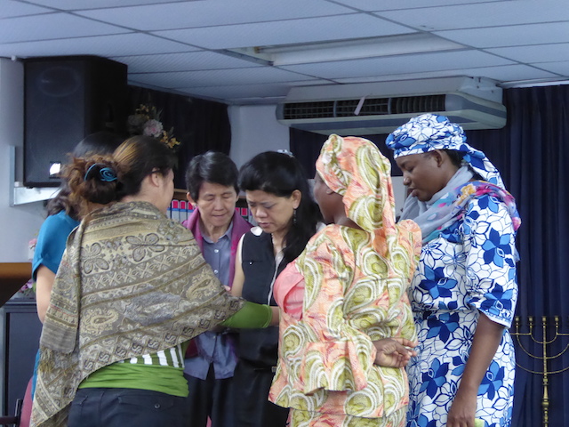 Sisters-in-Christ coming together during the prayer meeting after church to pray for one another, at First Assembly of God, Kota Bahru