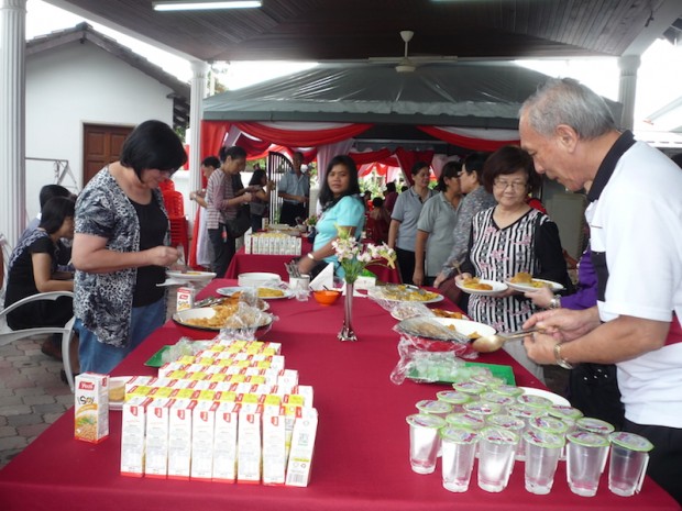 Home residents and guests helping themselves with refreshments during the launch