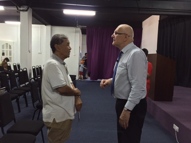 Pastor Ross praying for healing, for one of the attendees