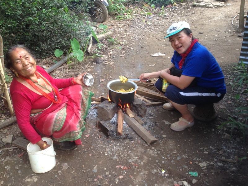 Elina learning to cook dal bhat in a village ministry at Nepal