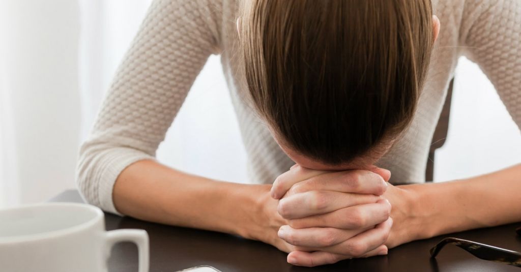 32805-prayer-woman-womanwithheadondesk-desk-headdown-1200w-tn