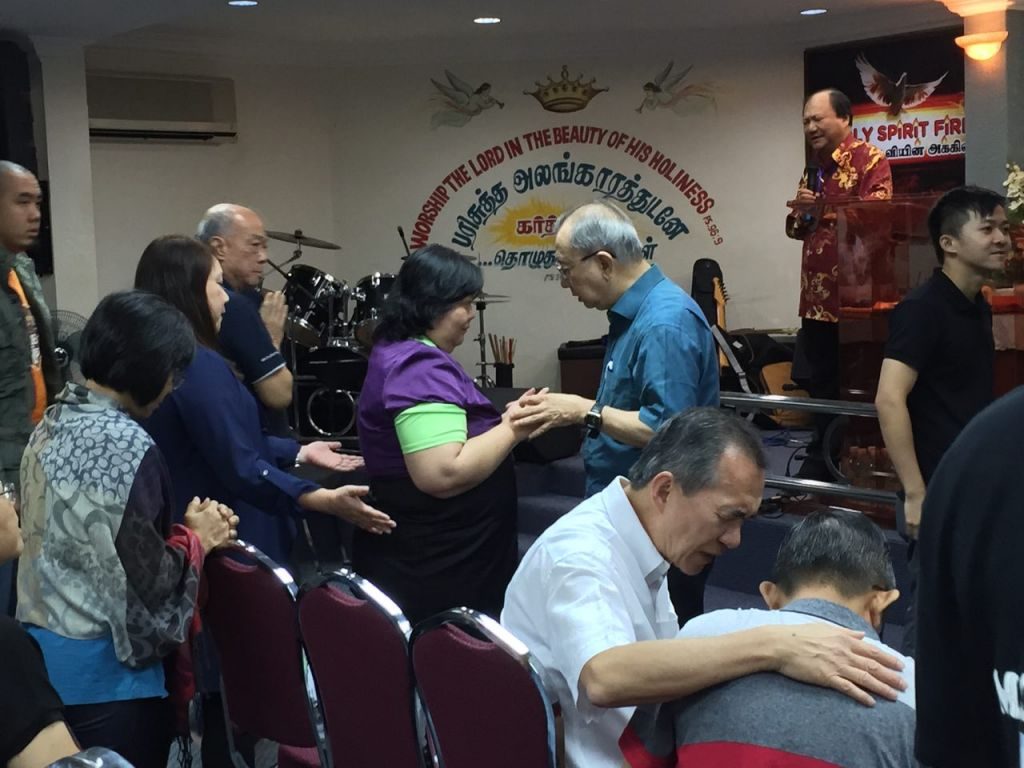 Pastor Derek Hong (3rd from right) and another speaker, Pastor Daniel Ho (2nd from right) praying for the church pastors and leaders of PAAG