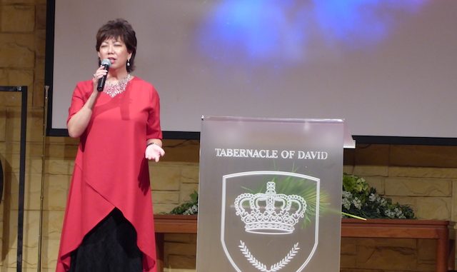 Pastor Irene Chong praying for the congregation